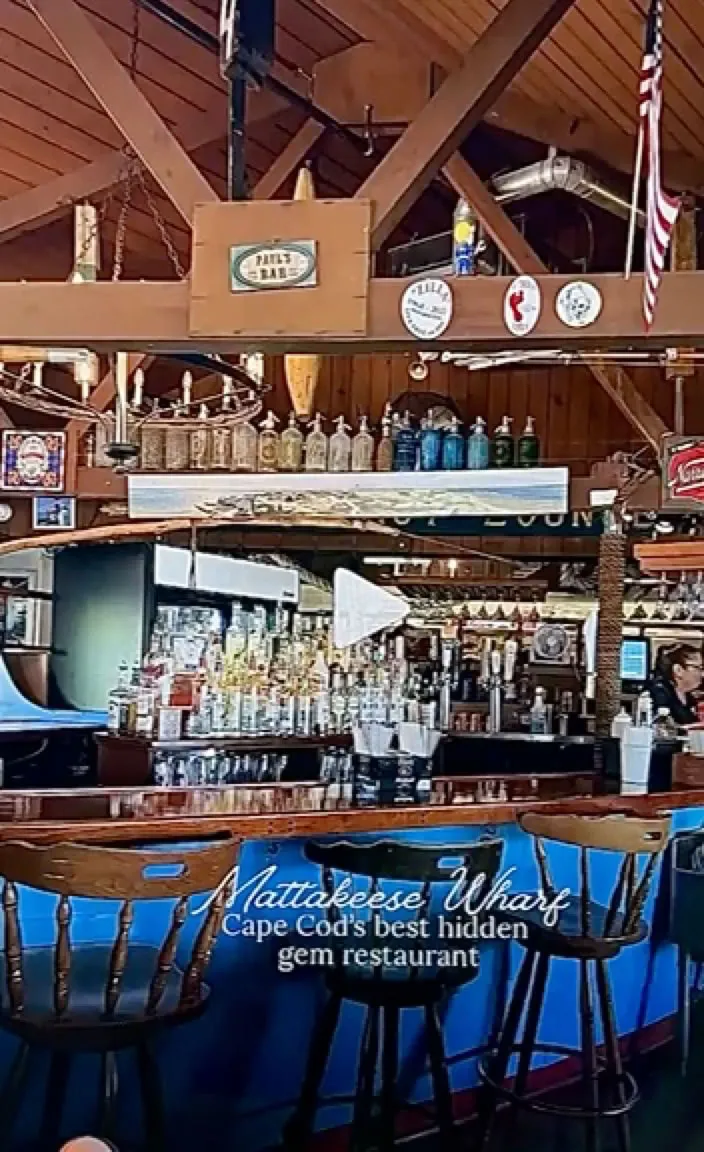 Bottles and beams behind the bar at Mattakeese Wharf