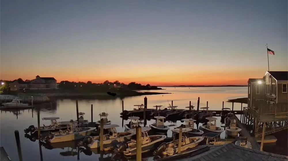 Orange sunset over the boats at Mattakeese Wharf