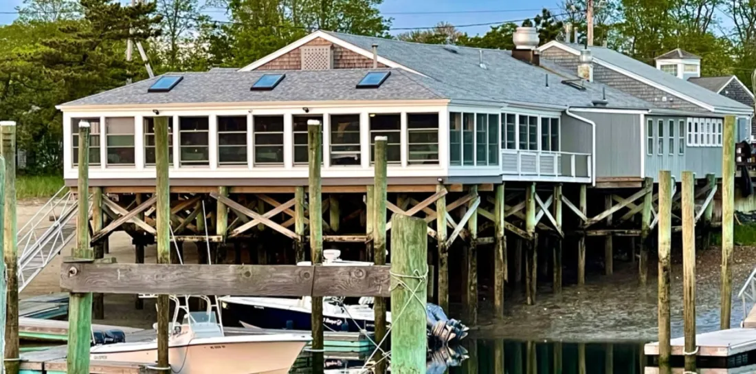 Mattakeese Wharf's waterfront dining room on pilings over Barnstable Harbor